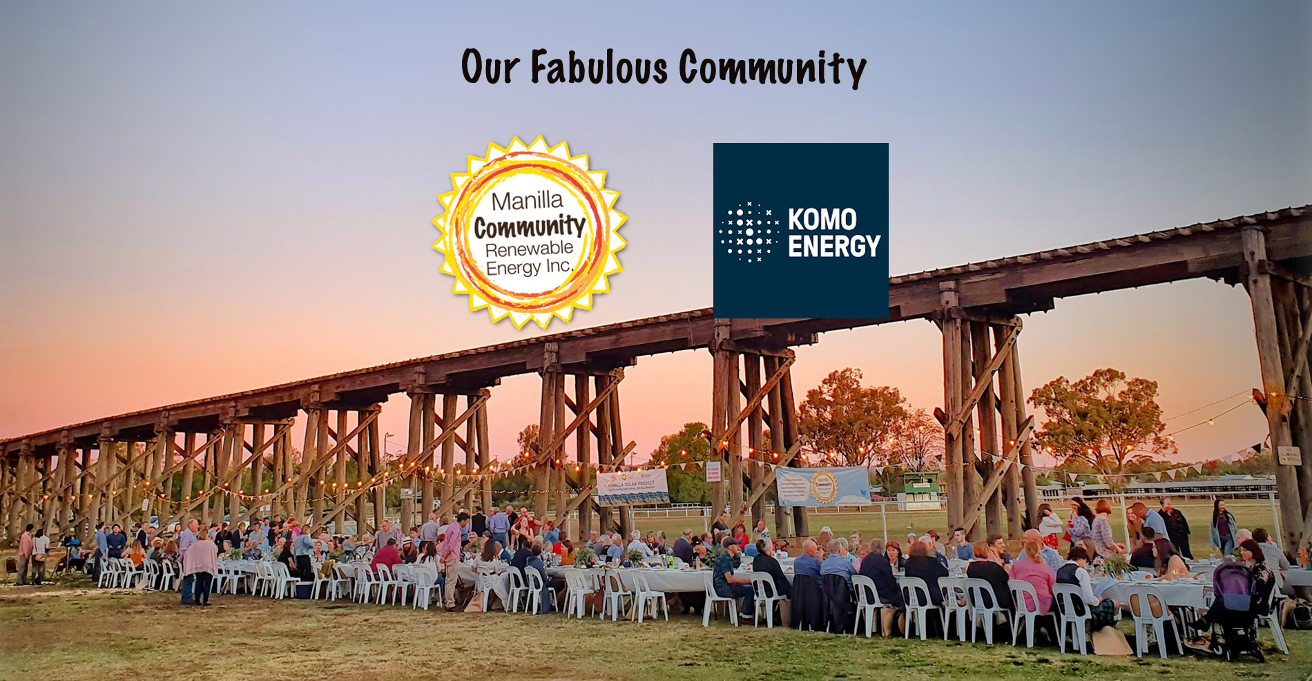 titled our fabulous community, with logos for Manilla Community Renewable Energy Inc. and Komo Energy over a view of people eating at a Long Lunch event beside the Manilla Viaduct
